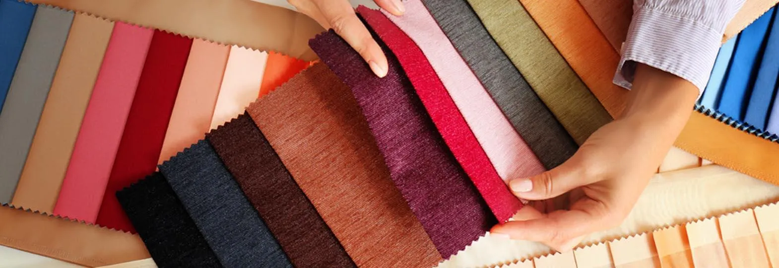 Premium fabric color swatches displayed in multiple shades for clothing and textile selection.