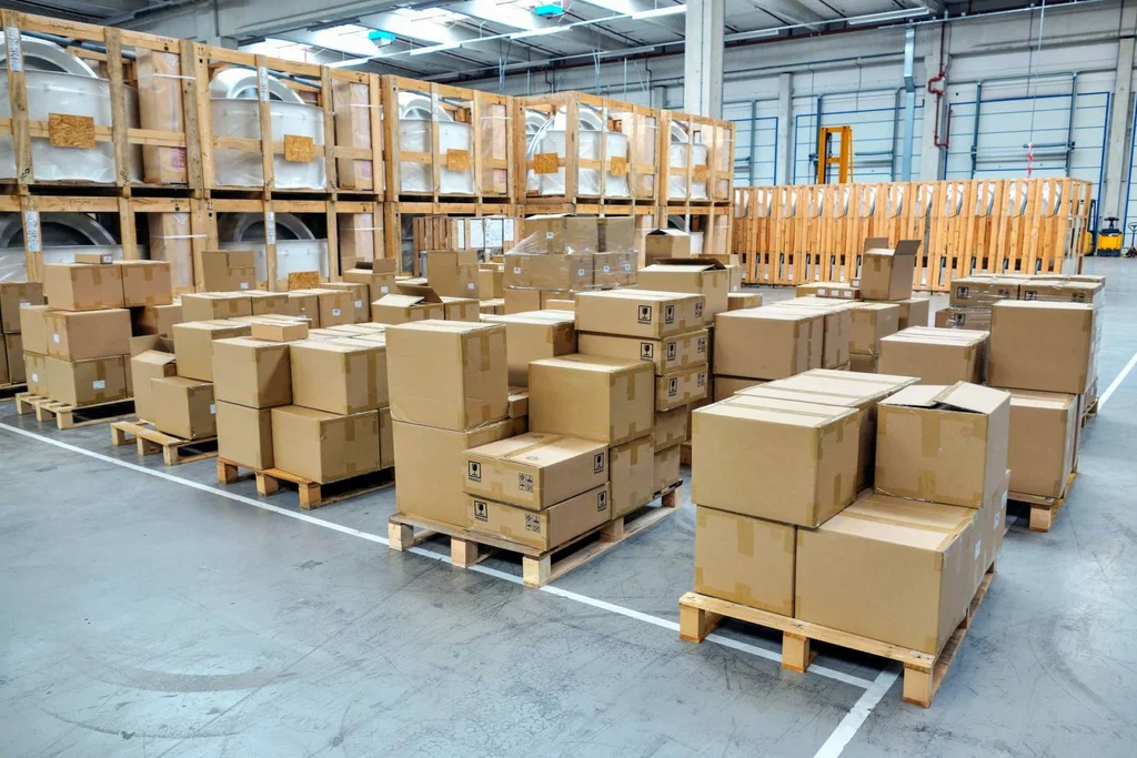 Stacked cardboard boxes on pallets in warehouse ready for storage shipping and distribution